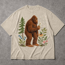 SF_COLOR=sand; SF_ITEM=adult-t-shirt; SF_ROLE=main; Funny Bigfoot Blowing A Dandelion T-Shirt Retro Floral Sasquatch Outdoors Tee - Sand Adult T-Shirt product image