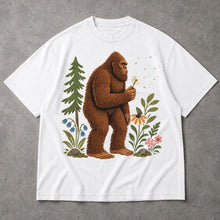 SF_COLOR=white; SF_ITEM=adult-t-shirt; SF_ROLE=main; Funny Bigfoot Blowing A Dandelion T-Shirt Retro Floral Sasquatch Outdoors Tee - White Adult T-Shirt product image