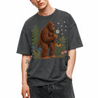 SF_COLOR=dark-heather; SF_ITEM=adult-t-shirt; SF_ROLE=gallery; Funny Bigfoot Blowing A Dandelion T-Shirt Retro Floral Sasquatch Outdoors Tee - Dark Heather Adult T-Shirt product image