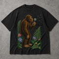 SF_COLOR=black; SF_ITEM=adult-t-shirt; SF_ROLE=main; Retro Bigfoot Blowing A Dandelion T-Shirt Vintage Sasquatch Floral Nature Tee - Black Adult T-Shirt product image
