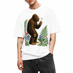 SF_COLOR=white; SF_ITEM=adult-t-shirt; SF_ROLE=gallery; Retro Bigfoot Blowing A Dandelion T-Shirt Vintage Sasquatch Floral Nature Tee - White Adult T-Shirt product image