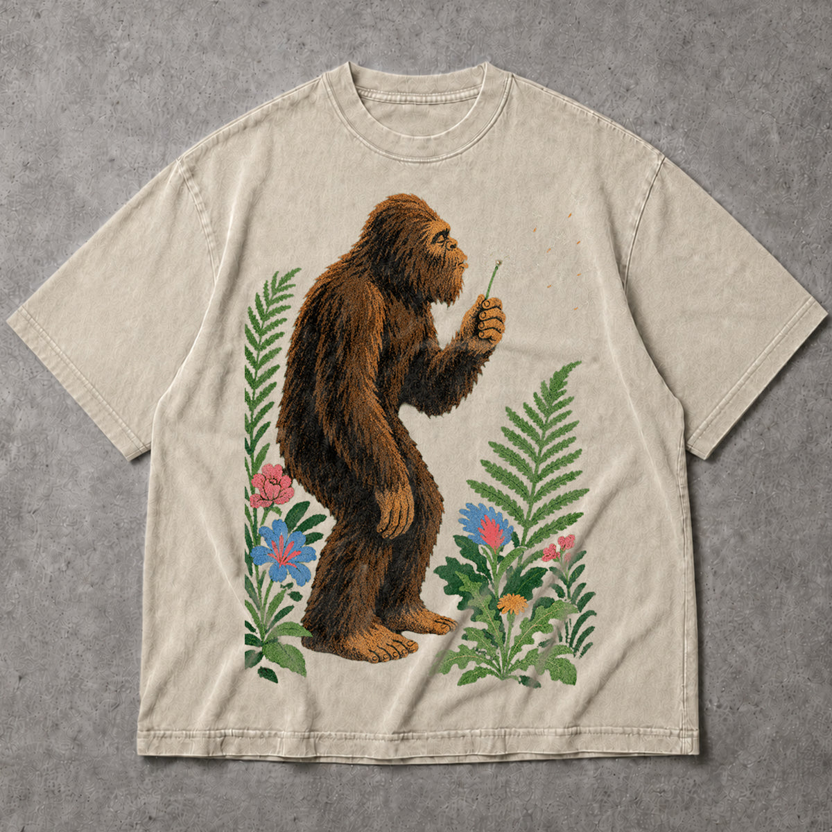 SF_COLOR=sand; SF_ITEM=adult-t-shirt; SF_ROLE=main; Retro Bigfoot Blowing A Dandelion T-Shirt Vintage Sasquatch Floral Nature Tee - Sand Adult T-Shirt product image