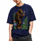 SF_COLOR=navy; SF_ITEM=adult-t-shirt; SF_ROLE=gallery; Retro Bigfoot Blowing A Dandelion T-Shirt Vintage Sasquatch Floral Nature Tee - Navy Adult T-Shirt product image