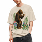 SF_COLOR=sand; SF_ITEM=adult-t-shirt; SF_ROLE=gallery; Retro Bigfoot Blowing A Dandelion T-Shirt Vintage Sasquatch Floral Nature Tee - Sand Adult T-Shirt product image