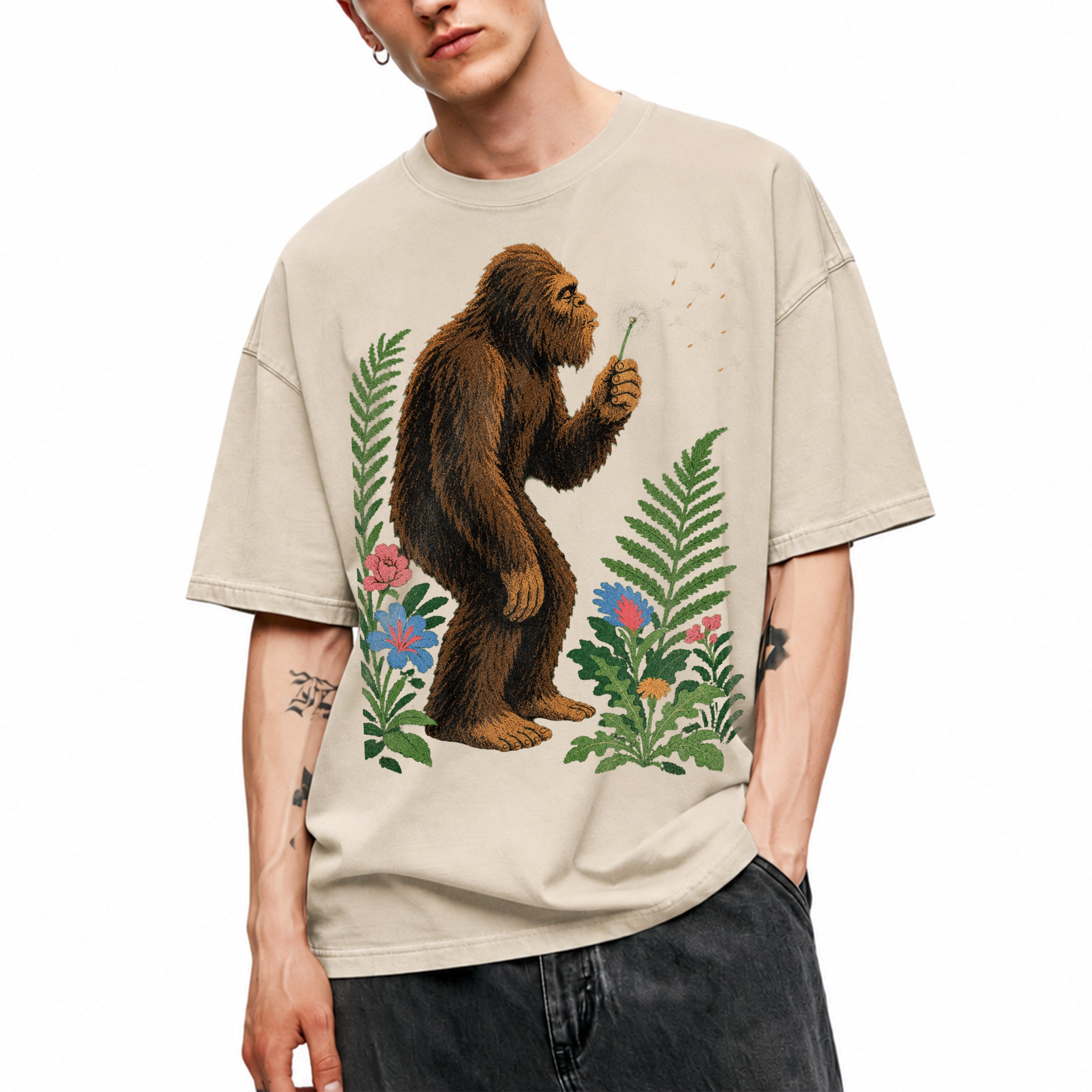 SF_COLOR=sand; SF_ITEM=adult-t-shirt; SF_ROLE=gallery; Retro Bigfoot Blowing A Dandelion T-Shirt Vintage Sasquatch Floral Nature Tee - Sand Adult T-Shirt product image